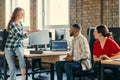 A diverse group of young business individuals congregates in a modern startup coworking center, embodying collaborative Royalty Free Stock Photo