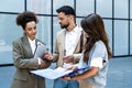 Diverse group of young business people outside office building, discussing and talking man and woman solving new construction plan Royalty Free Stock Photo