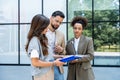 Diverse group of young business people outside office building, discussing and talking man and woman solving new construction plan Royalty Free Stock Photo