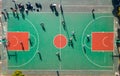 Diverse group of young men playing an active game of basketball on an outdoor court. Royalty Free Stock Photo