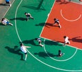 Diverse group of young men playing an active game of basketball on an outdoor court. Royalty Free Stock Photo