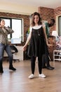 Diverse group of young people dancing in living room at wine party while celebrating birthday Royalty Free Stock Photo