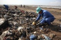 Diverse group of young volunteers actively participating in outdoor garbage cleaning project