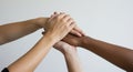 Diverse Hands Piled Together Against White Backdrop Showing Unity Royalty Free Stock Photo