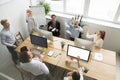 Diverse happy office team launching paper planes together, top v