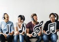 Diverse happy people holding musical icons