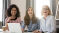 Diverse happy young and old busineswomen laughing engaged in meeting Royalty Free Stock Photo