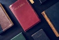 Diverse holy bibles on black background