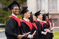 Diverse international students with diplomas attending graduation ceremony Royalty Free Stock Photo