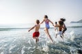 Diverse kids running at the beach