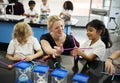 Diverse kindergarten students holding learning structures from t