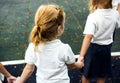 Diverse kindergarten students standing holding hands together Royalty Free Stock Photo