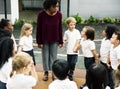 Diverse kindergarten students standing holding hands together Royalty Free Stock Photo