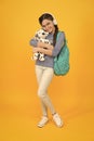 Diverse learning environments designed to meet the needs. Teen with backpack. Cute smiling schoolgirl carry soft toy dog