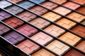 diverse makeup palettes stacked together