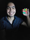 Diverse Male And Happiness With Rubiks Cube Isolated