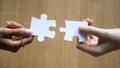 Diverse man and woman hands holding joining pieces connecting puzzle Royalty Free Stock Photo