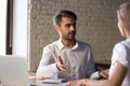 Diverse colleagues have conversation discussing business project