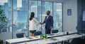 In Diverse Modern Office: Business Meeting of Businessman and Businesswoman Closing the Deal with