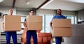 Diverse Movers Professional Relocation Services: Carrying Boxes Inside Royalty Free Stock Photo