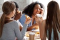 Diverse cheerful schoolmates laughing eating pizza together Royalty Free Stock Photo