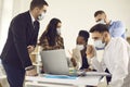 Diverse multiethnic business team in protective masks working in modern office Royalty Free Stock Photo