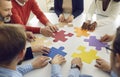 Diverse multiethnic people group collaborating assembling puzzle pieces together Royalty Free Stock Photo