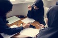 Diverse muslim girls studying in classroom