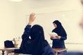 Diverse muslim girls studying in classroom