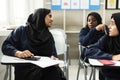 Diverse muslim girls studying in classroom