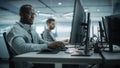 Diverse Office: Black IT Programmer Working on Desktop Computer. Male Specialist Creating Innovative