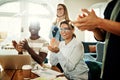 Diverse office colleagues smiling and clapping during an office Royalty Free Stock Photo
