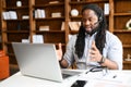An African-American guy wearing headset using a laptop Royalty Free Stock Photo