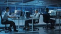 Diverse Office at Night: Multi-Ethnic Team of Young Programmers Working on Desktop Computers Royalty Free Stock Photo