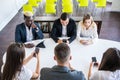 Diverse office people working on mobile phones. Corporate employees holding smartphones at meeting. serious multiracial Royalty Free Stock Photo