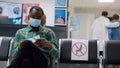 Diverse patients sitting in waiting room lobby to attend checkup visit Royalty Free Stock Photo