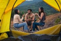 Diverse people of caucasian and asian friends having fun together traveling and camping at natural park in summer Royalty Free Stock Photo
