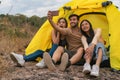 Diverse people of caucasian and asian friends having fun together traveling and camping in natural resort