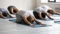 Diverse people doing child exercise at group lesson, practicing yoga Royalty Free Stock Photo