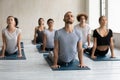 Diverse people doing cobra exercise at group lesson, practicing yoga Royalty Free Stock Photo