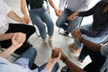 Diverse people group sitting on chairs in circle uniting hands Royalty Free Stock Photo