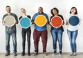 Diverse people holding blank round board