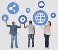 Diverse people holding blue networking icons Royalty Free Stock Photo