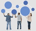 Diverse people holding blue round icons Royalty Free Stock Photo