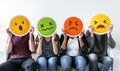 Diverse people holding emoticon icons Royalty Free Stock Photo