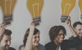 Diverse People holding lightbulb icons Royalty Free Stock Photo