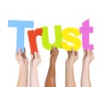 Diverse People Holding Single Word Trust
