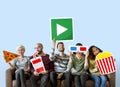 Group of diverse friends holding movie emoticons Royalty Free Stock Photo