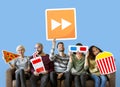 Group of diverse friends holding movie emoticons