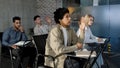 Diverse people sit in classroom at desk actively study science classmates students listen lecture seminar in college